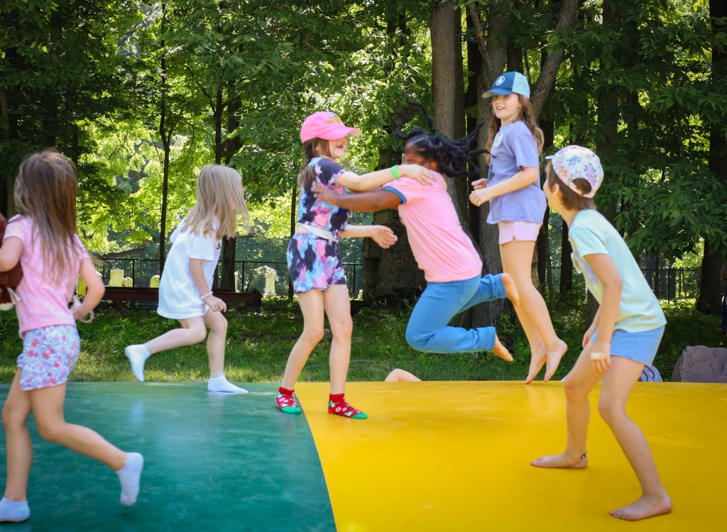 Girl scouts bouncing on a jumping pillow